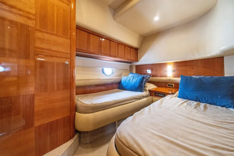Hakuna Matata Yacht Photos Pics Luxurious cabin interior of 2007 Azimut 55 yacht with twin beds and wooden finishes.