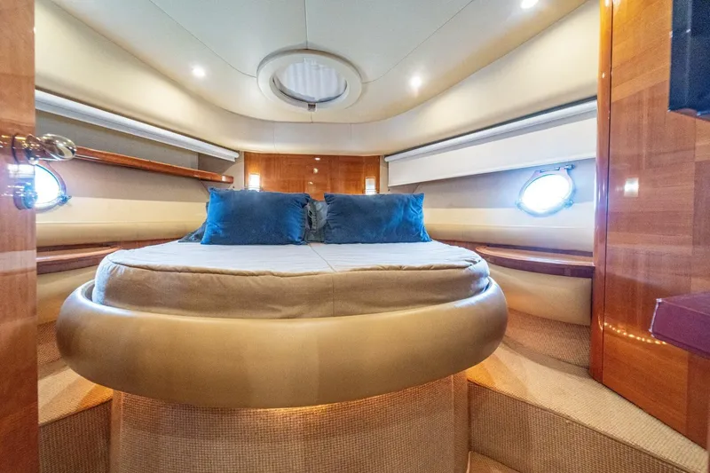 Hakuna Matata Yacht Photos Pics Luxurious interior of a 2007 Azimut 55 yacht with elegant bedding and ambient lighting.