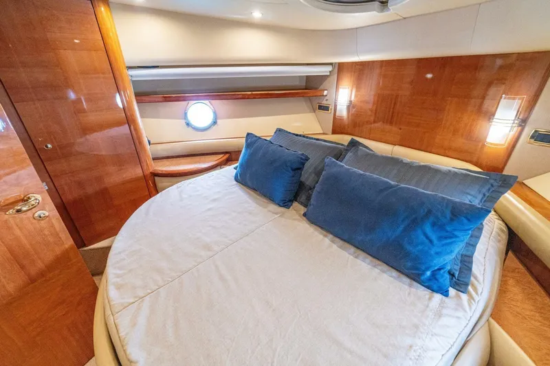 Hakuna Matata Yacht Photos Pics Luxurious bedroom interior of 2007 Azimut 55 yacht with elegant wood finish.