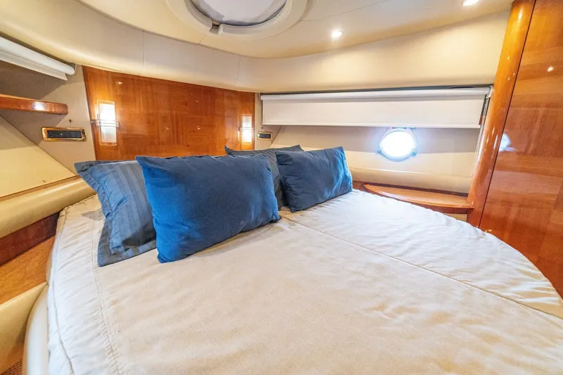 Hakuna Matata Yacht Photos Pics Luxurious cabin interior of 2007 Azimut 55 yacht with cozy bedding and elegant wood finish.