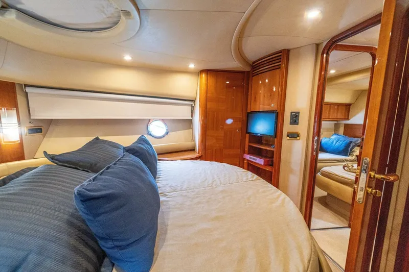 Hakuna Matata Yacht Photos Pics Luxurious interior of 2007 Azimut 55 yacht with cozy bedroom and elegant wood finishes.
