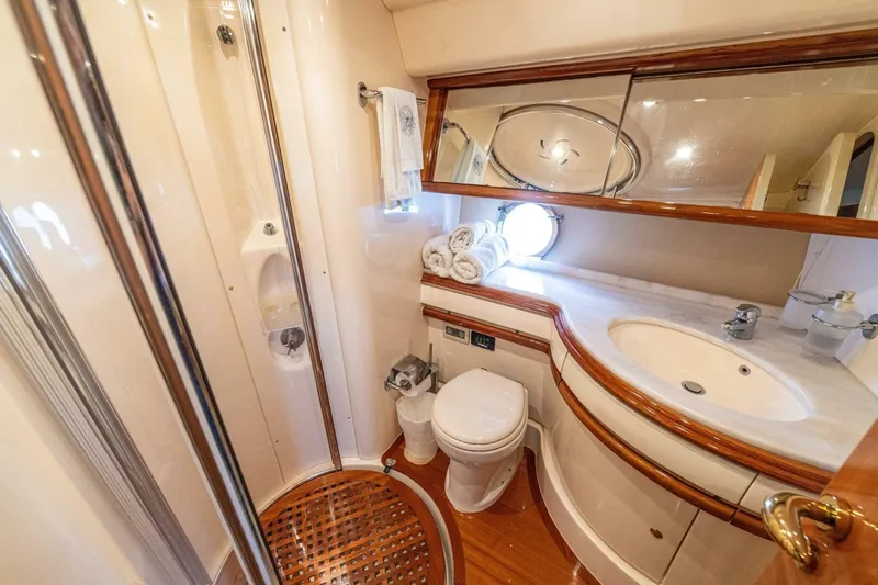 Hakuna Matata Yacht Photos Pics Luxurious bathroom in 2007 Azimut 55 yacht with elegant fixtures and wooden accents.