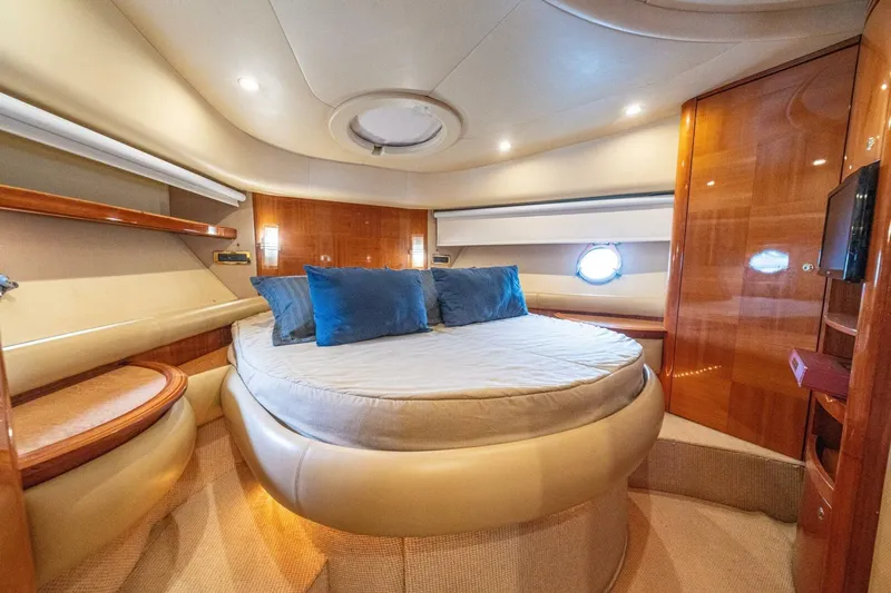 Hakuna Matata Yacht Photos Pics Luxurious bedroom interior of 2007 Azimut 55 yacht with round bed and elegant wood finish.