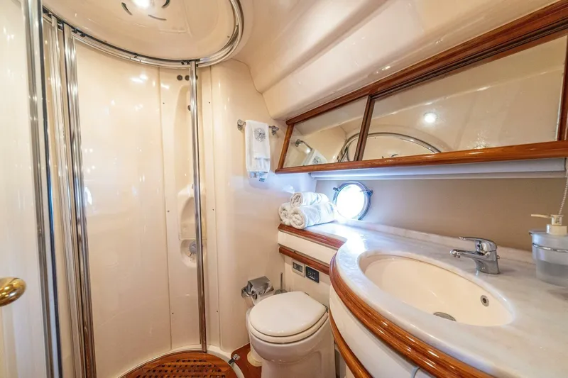 Hakuna Matata Yacht Photos Pics Luxurious bathroom in 2007 Azimut 55 yacht with shower, sink, and toilet.