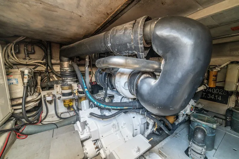 Hakuna Matata Yacht Photos Pics Engine room of a 2007 Azimut 55 yacht, showcasing complex machinery and piping.