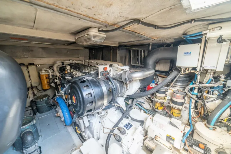 Hakuna Matata Yacht Photos Pics Engine room of a 2007 Azimut 55 yacht, showcasing complex machinery and components.