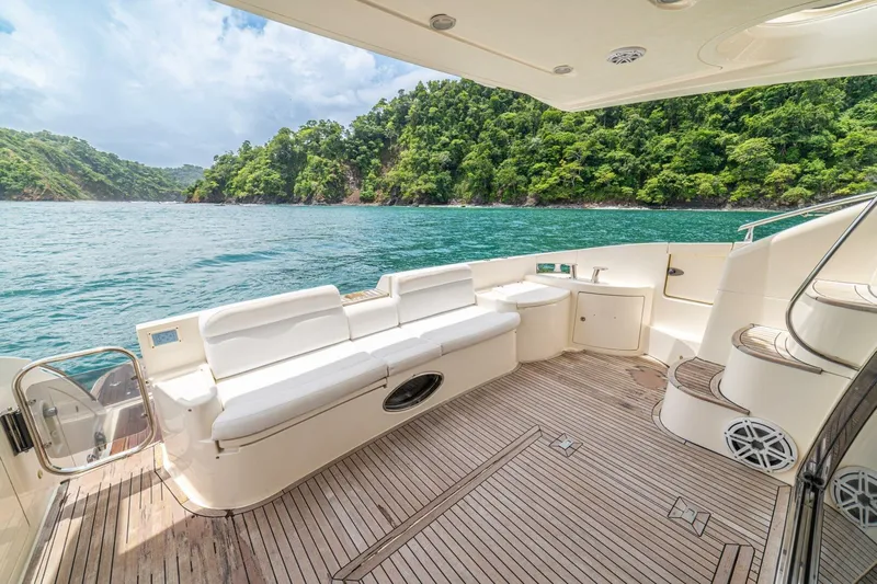 Hakuna Matata Yacht Photos Pics Luxurious 2007 Azimut 55 yacht deck with scenic ocean and lush green island view.