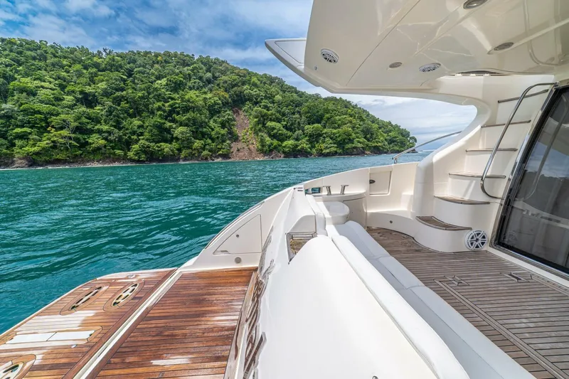 Hakuna Matata Yacht Photos Pics Luxurious 2007 Azimut 55 yacht deck with scenic ocean and lush green island view.