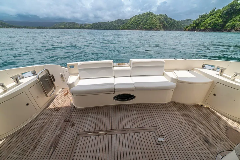 Hakuna Matata Yacht Photos Pics Luxury Azimut 55 yacht deck with seating, overlooking serene waters and lush green hills.