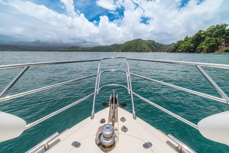 Hakuna Matata Yacht Photos Pics Bow view from 2007 Azimut 55 yacht cruising in scenic tropical waters.