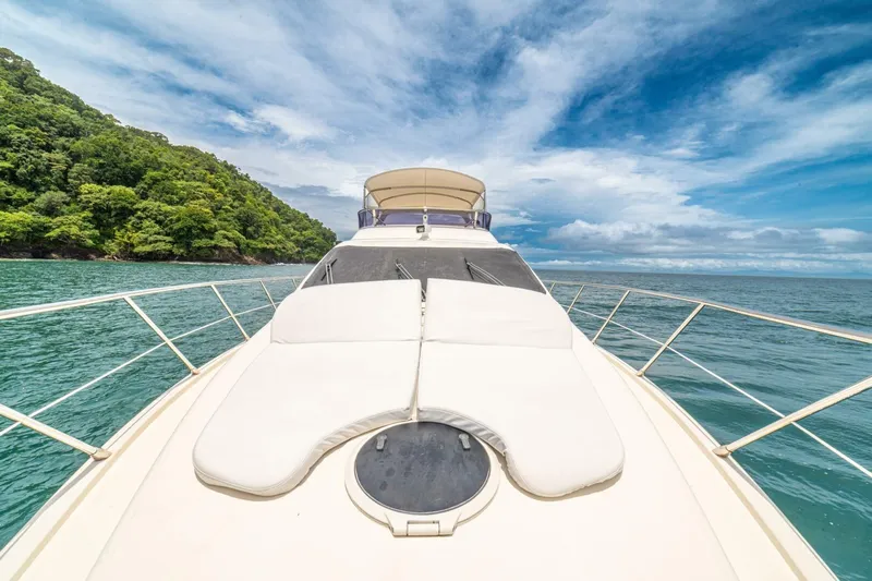 Hakuna Matata Yacht Photos Pics 2007 Azimut 55 yacht cruising on turquoise waters under a clear blue sky.