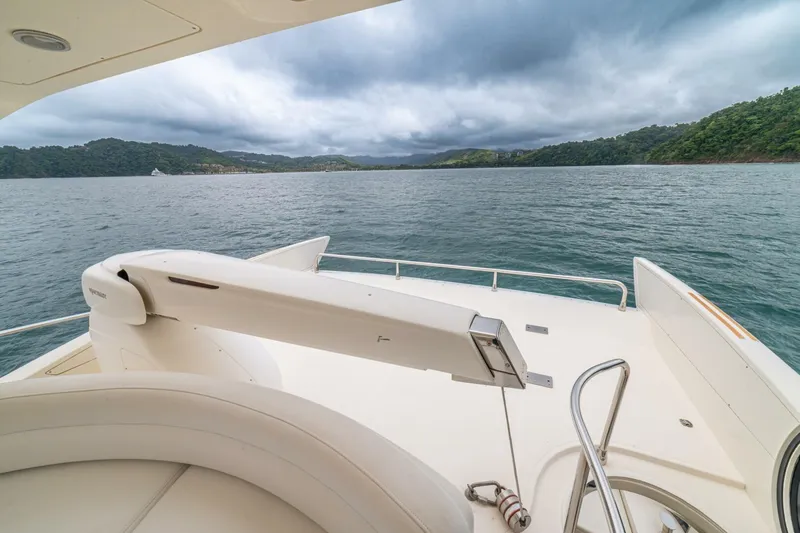 Hakuna Matata Yacht Photos Pics 2007 Azimut 55 yacht deck overlooking serene waters and lush green hills.