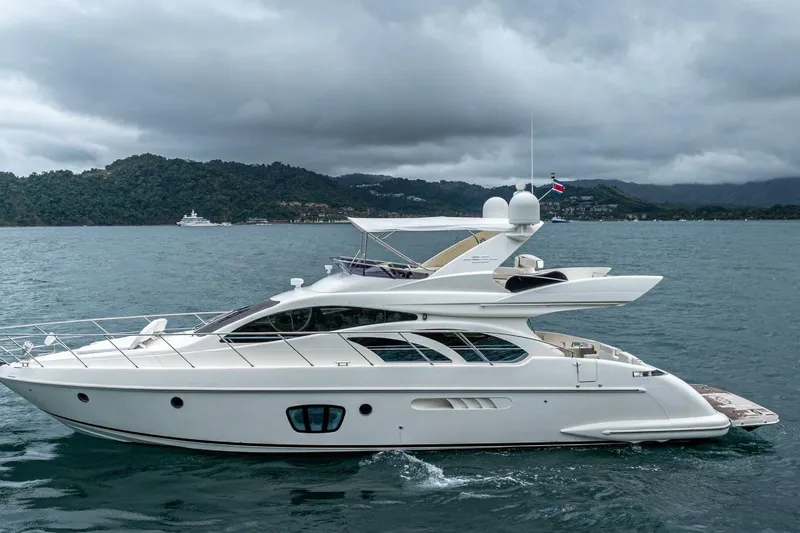 Hakuna Matata Yacht Photos Pics 2007 Azimut 55 yacht cruising on a scenic, cloudy seascape.