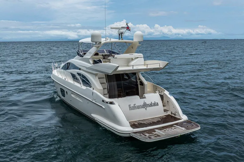 Hakuna Matata Yacht Photos Pics Luxury 2007 Azimut 55 yacht cruising on open sea under clear skies.