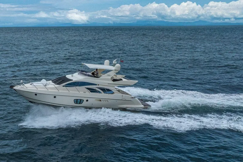 Hakuna Matata Yacht Photos Pics 2007 Azimut 55 yacht cruising on open sea under cloudy sky.