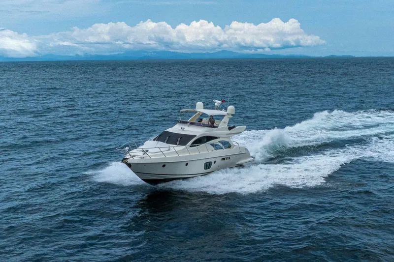 Hakuna Matata Yacht Photos Pics 2007 Azimut 55 yacht cruising on open sea under clear skies.