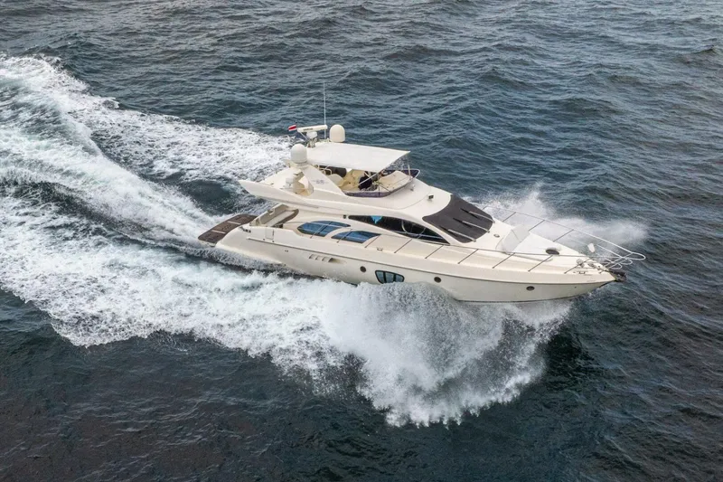 Hakuna Matata Yacht Photos Pics Aerial view of 2007 Azimut 55 yacht cruising on open water.