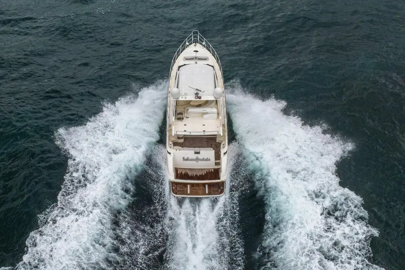 Hakuna Matata Yacht Photos Pics Aerial view of 2007 Azimut 55 yacht cruising through ocean waves.