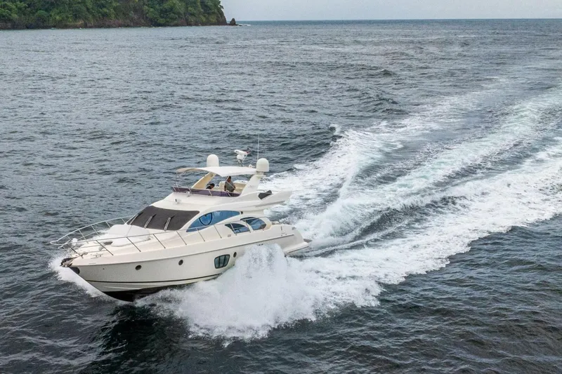 Hakuna Matata Yacht Photos Pics 2007 Azimut 55 yacht cruising on open water, creating a dynamic wake.