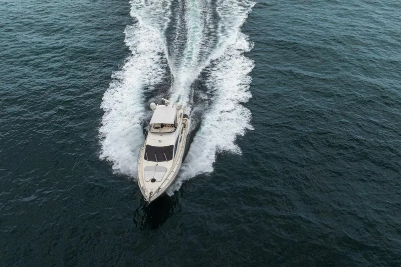 Hakuna Matata Yacht Photos Pics 2007 Azimut 55 yacht cruising on open water, aerial view.