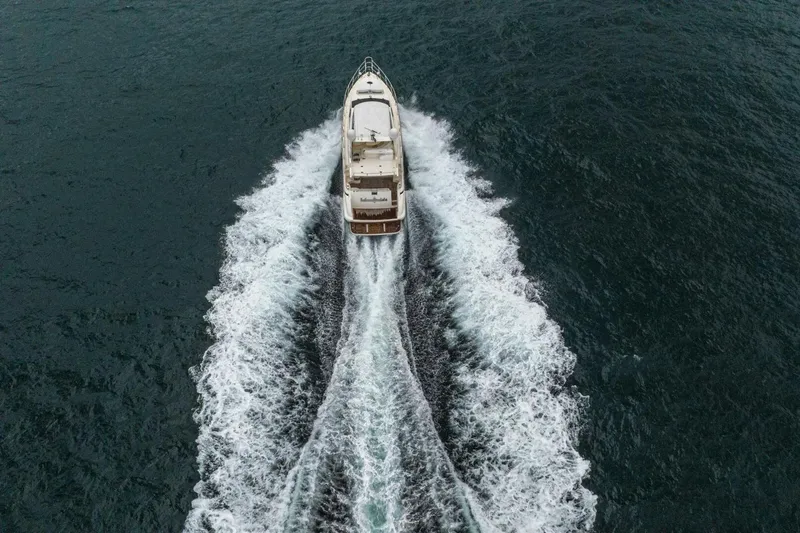 Hakuna Matata Yacht Photos Pics Aerial view of 2007 Azimut 55 yacht cruising through ocean waves.