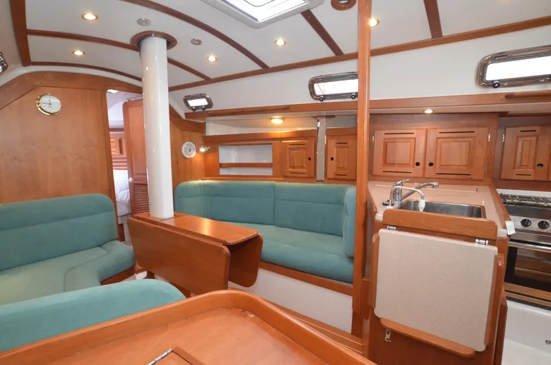 Tahlequah Yacht Photos Pics Interior of 2020 Tartan 365 yacht with wood finish and teal seating.