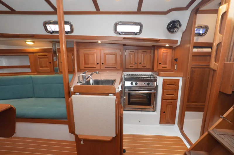 Tahlequah Yacht Photos Pics Interior of 2020 Tartan 365 sailboat with wooden cabinetry and compact kitchen.