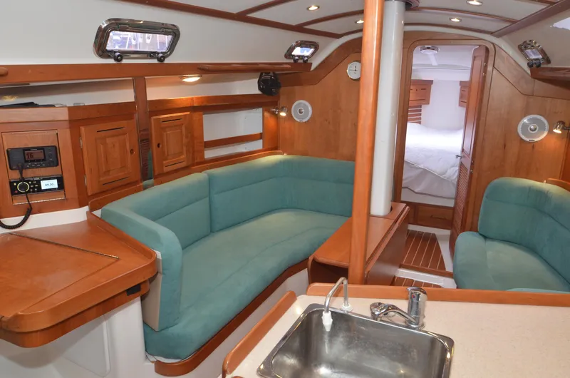 Tahlequah Yacht Photos Pics Interior of 2020 Tartan 365 yacht with wooden cabinetry and teal seating.