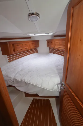 Tahlequah Yacht Photos Pics Cozy cabin interior of 2020 Tartan 365 yacht with wooden accents and comfortable bedding.