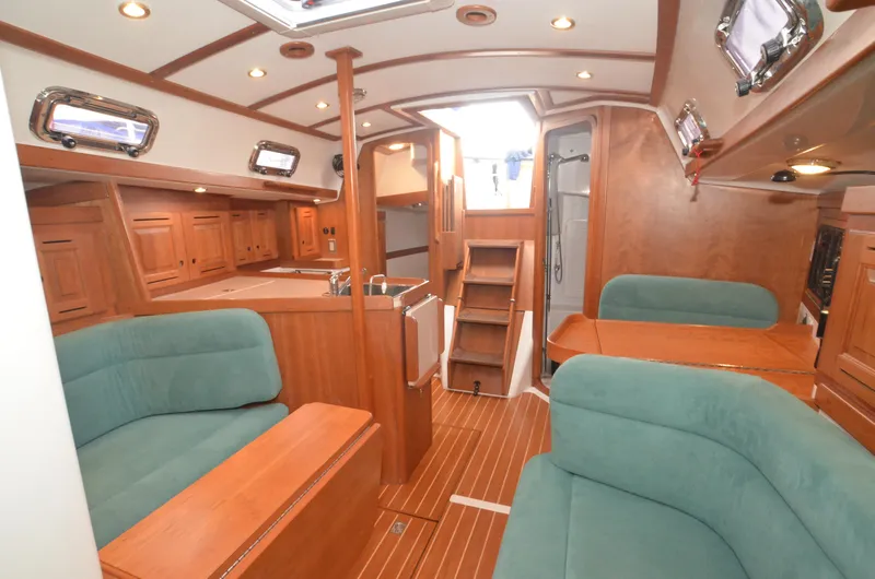 Tahlequah Yacht Photos Pics Luxurious 2020 Tartan 365 yacht interior with wooden finish and teal seating.