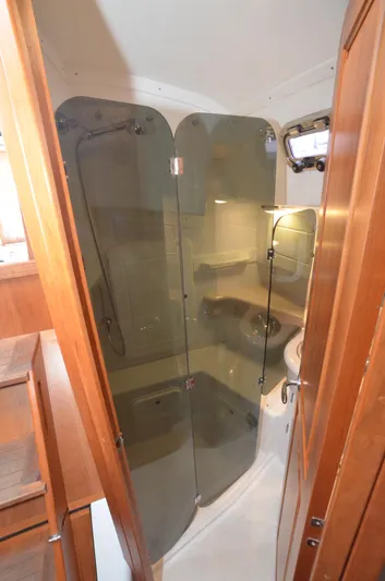 Tahlequah Yacht Photos Pics 2020 Tartan 365 yacht bathroom with glass shower enclosure and wooden cabinetry.
