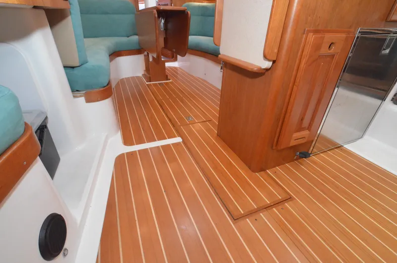 Tahlequah Yacht Photos Pics Interior of 2020 Tartan 365 yacht with wooden flooring and teal seating.