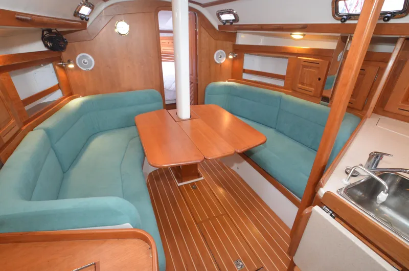 Tahlequah Yacht Photos Pics Cozy interior of 2020 Tartan 365 sailboat with teal seating and wooden finishes.