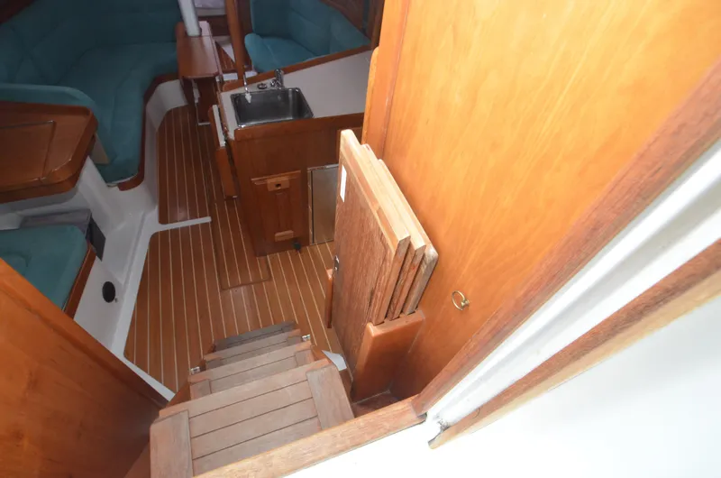 Tahlequah Yacht Photos Pics Interior of 2020 Tartan 365 sailboat with wooden flooring and compact kitchen area.