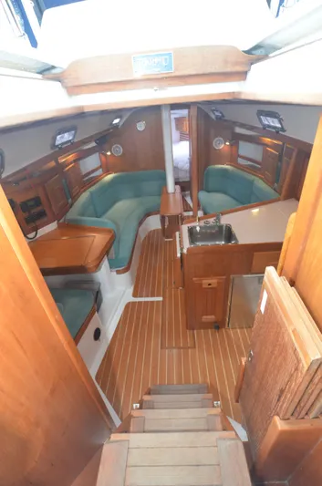 Tahlequah Yacht Photos Pics Interior of 2020 Tartan 365 sailboat with wood finish and green seating.