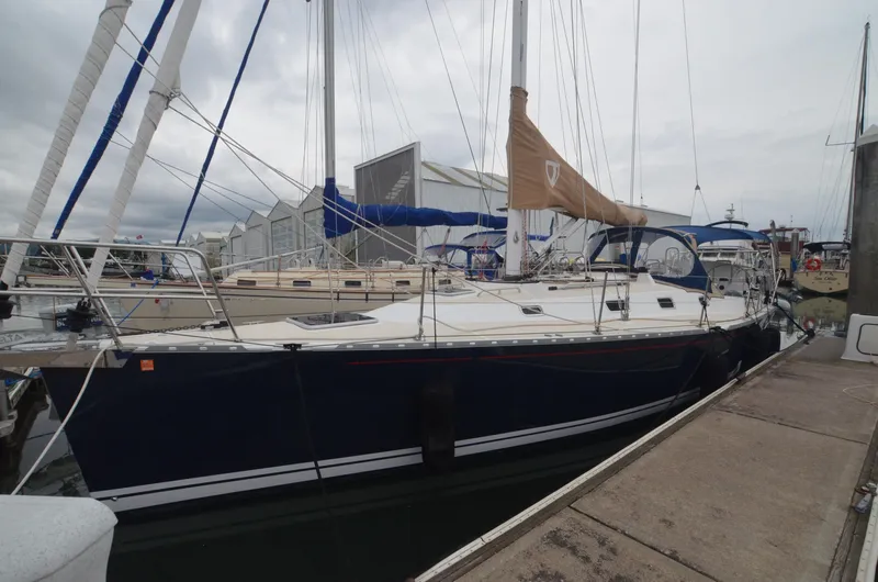 Tahlequah Yacht Photos Pics Sailboat docked at marina, Tartan 365 model, 2020, with blue hull and tan sail cover.