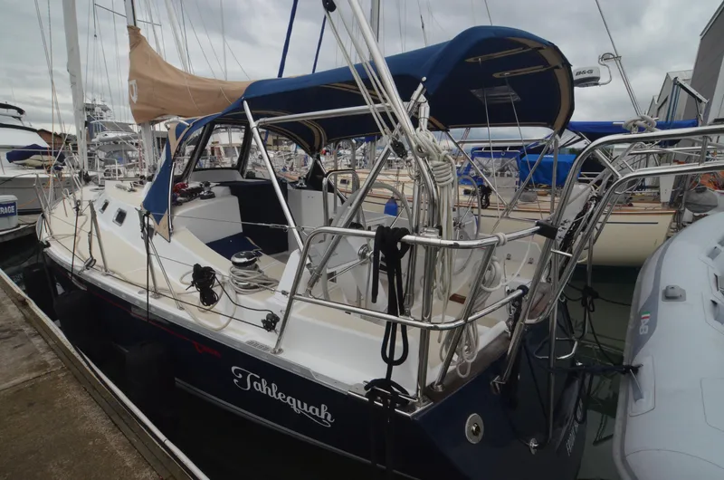Tahlequah Yacht Photos Pics 2020 Tartan 365 sailboat docked, featuring blue canopy and sleek design.