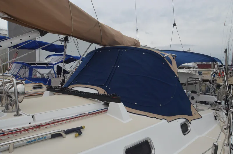 Tahlequah Yacht Photos Pics Sailboat Tartan 365, 2020 model, with blue canvas cover and beige accents at dock.