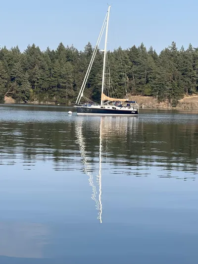 Tahlequah Yacht Photos Pics Sailboat Tartan 365 (2020) on calm lake with forested background.