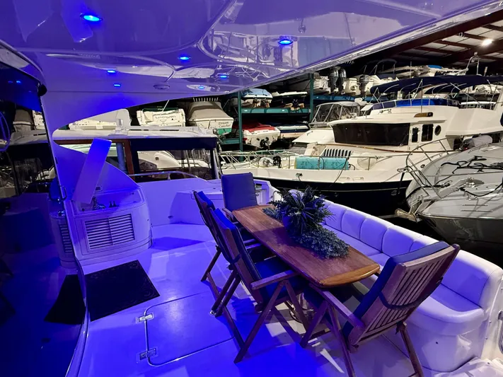 Tenacity Yacht Photos Pics Luxurious 2005 Marquis 65 yacht interior with elegant seating and ambient blue lighting.