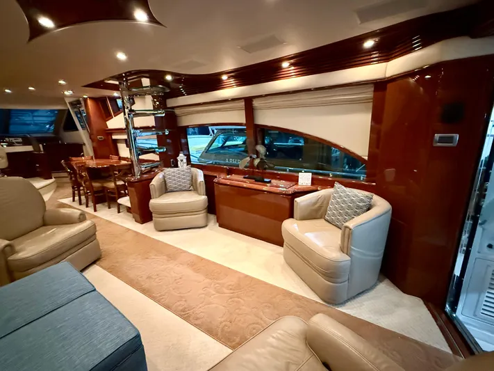 Tenacity Yacht Photos Pics Luxurious interior of a 2005 Marquis 65 yacht with elegant seating and wood finishes.