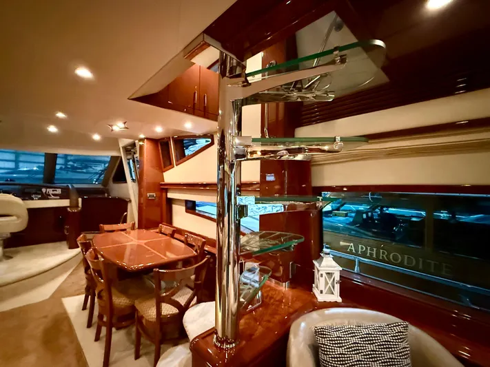 Tenacity Yacht Photos Pics Luxurious interior of a 2005 Marquis 65 yacht with elegant dining area and modern design.