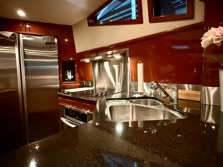 Tenacity Yacht Photos Pics Luxurious kitchen interior of a 2005 Marquis 65 yacht with modern appliances and sleek design.