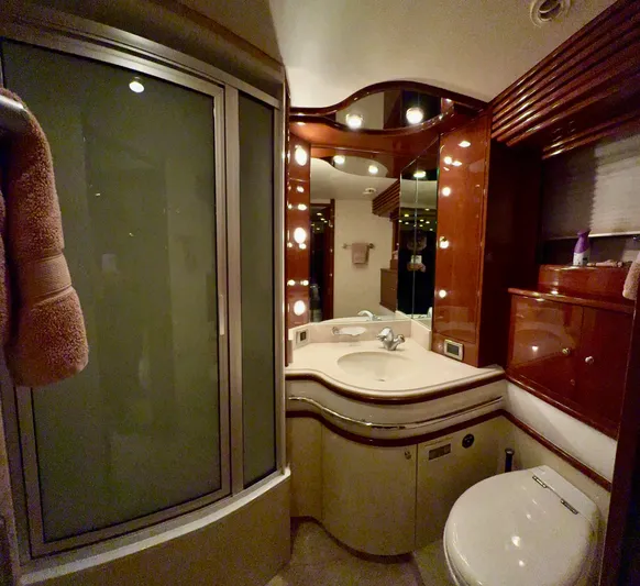 Tenacity Yacht Photos Pics Luxurious bathroom interior of a 2005 Marquis 65 yacht with elegant fixtures and lighting.