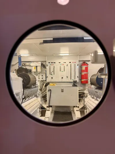 Tenacity Yacht Photos Pics Engine room of a 2005 Marquis 65 yacht, featuring control panels and equipment.