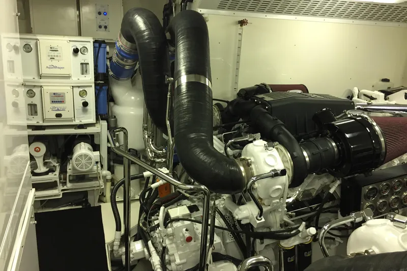 Front Row Yacht Photos Pics Engine room of a 2006 NorthCoast PILOTHOUSE yacht with complex machinery and equipment.