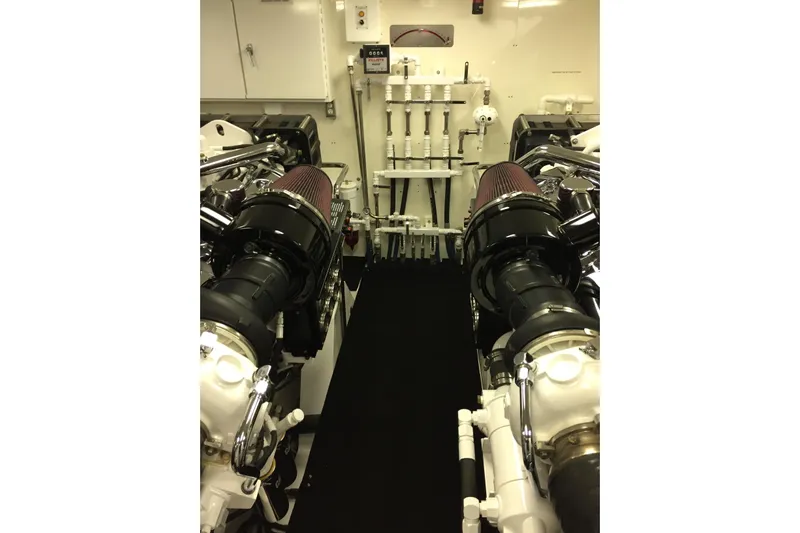 Front Row Yacht Photos Pics Engine room of 2006 NorthCoast PILOTHOUSE yacht, showcasing dual engines and mechanical systems.