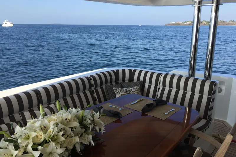 Front Row Yacht Photos Pics Luxury dining area on 2006 NorthCoast PILOTHOUSE yacht with ocean view and elegant decor.