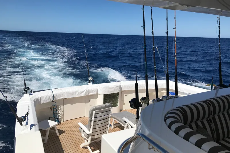 Front Row Yacht Photos Pics 2006 NorthCoast PILOTHOUSE boat with fishing rods, ocean view, and deck seating.