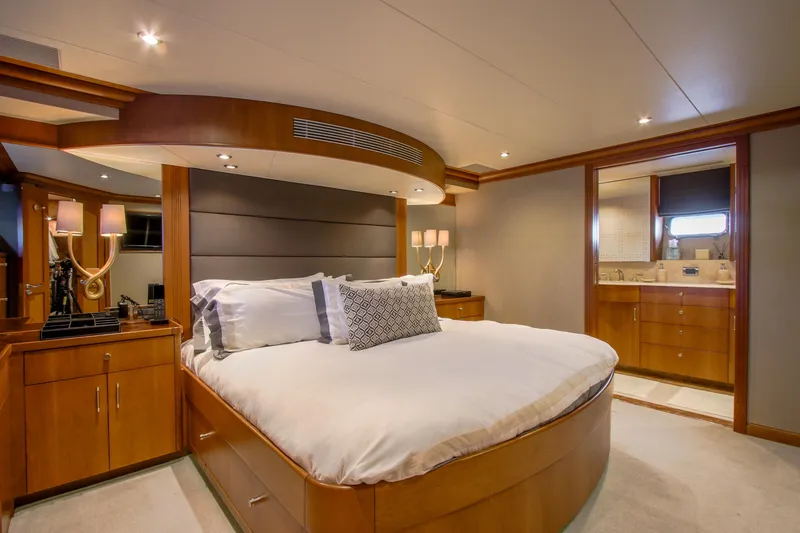 Front Row Yacht Photos Pics Luxurious bedroom interior of 2006 Northcoast Yachts Yachtfisher, featuring elegant wood finishes.